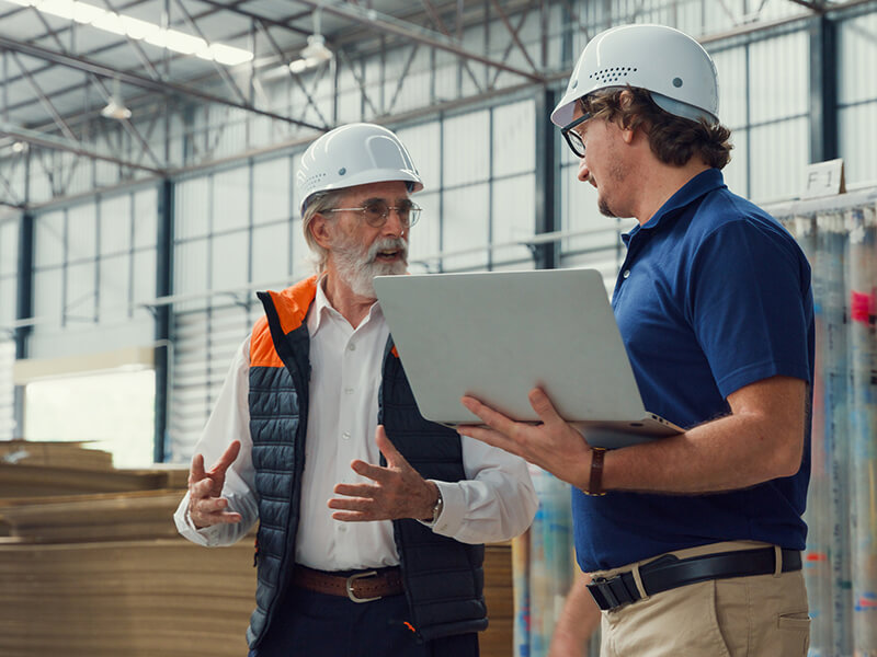 Warehouse employees review freight audit report